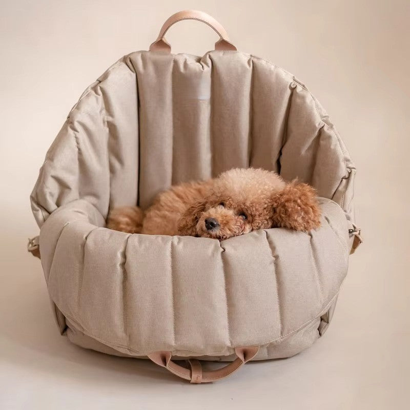 caniche marron allongé dans sac transport chien kaki foncé